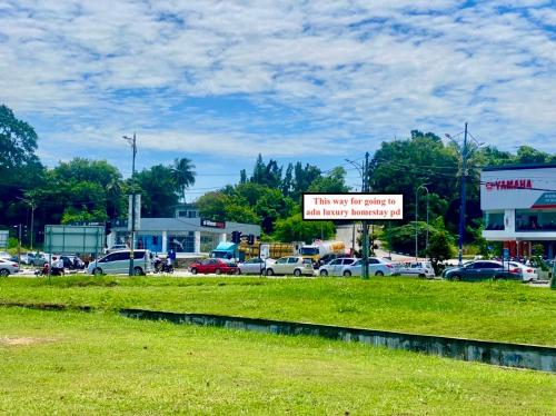 a sign that says no parking in a parking lot at ADN LUXURY Homestay KARAOKE, POOL,NETFLIX,ASTRO,BBQ in Port Dickson