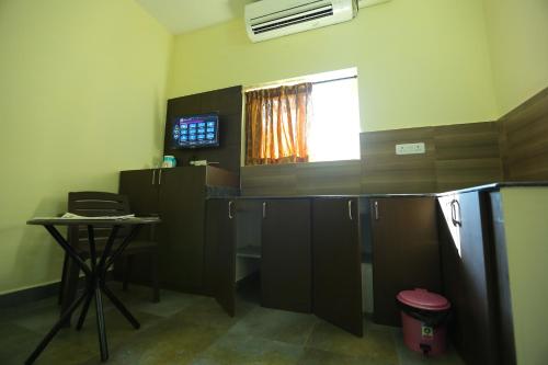 an office with a desk and a window in a room at Season 4 Residences -Thiruvanmiyur Near Tidel park Apollo Proton cancer center and IIT Madras Research Park in Chennai