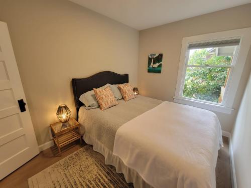 a bedroom with a large bed and a window at Sunny remodeled craftsman in Georgetown in Seattle