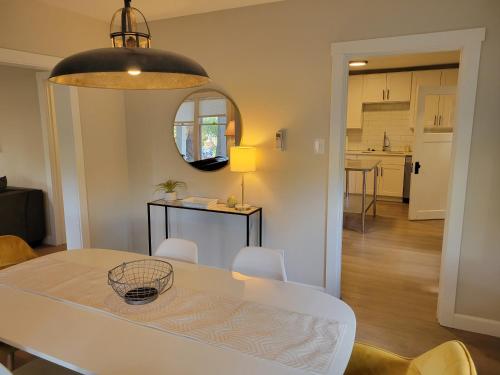 a dining room and kitchen with a white table and chairs at Modern Craftsman Garden Patio in Georgetown in Seattle
