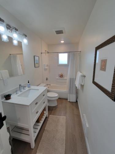 a white bathroom with a sink and a toilet at Modern Craftsman Garden Patio in Georgetown in Seattle