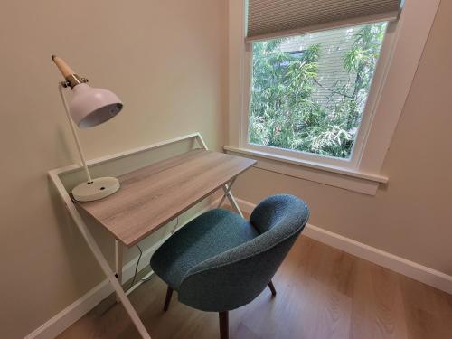 a desk with a chair and a lamp next to a window at Modern Craftsman Garden Patio in Georgetown in Seattle