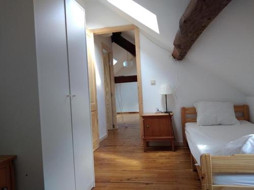 a bedroom with a bed and a dresser with a lamp at Gîte d'Hildegarde with sauna in Fallais