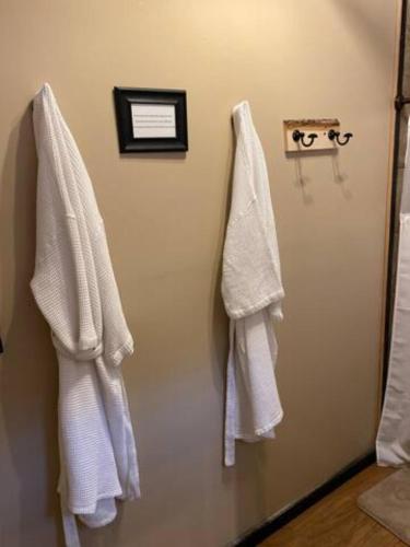 a bathroom with white towels hanging on a wall at The Outpost in Grand Rivers