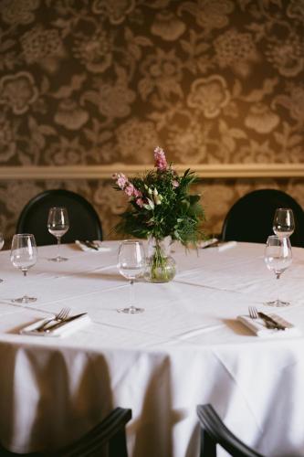 a table with a vase of flowers on it at Marine Troon in Troon