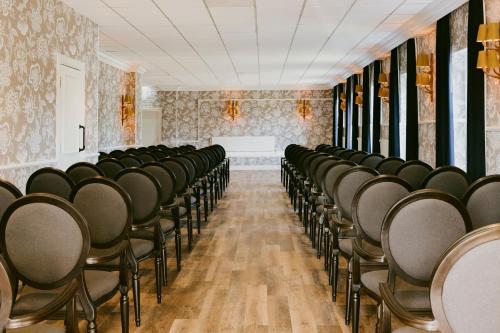 a room with rows of chairs and a table at Marine Troon in Troon