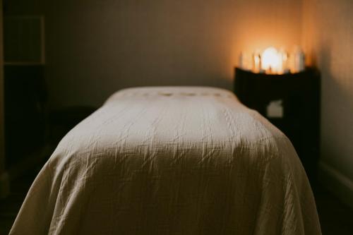 a bed in a room with a white blanket at Marine Troon in Troon