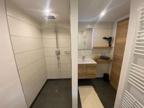 a bathroom with a shower and a sink at Ferienhaus Krallinger in Abtenau