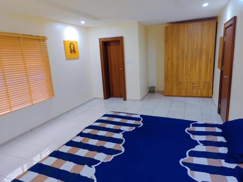 a blue rug on the floor in a room at Highly Secured 24 Hours Electricity Apartment in Garki