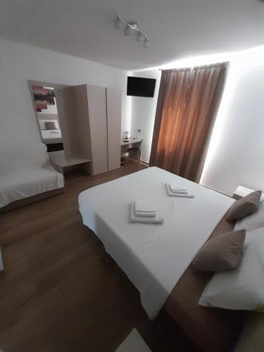 a living room with a white table and a couch at B&B ANGELA Valdinon in Predaia
