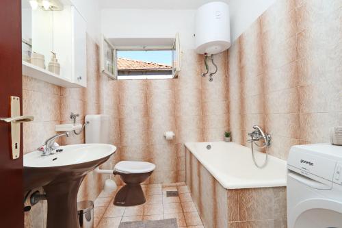 a small bathroom with a sink and a toilet at Apartments by the sea Brna, Korcula - 173 in Smokvica