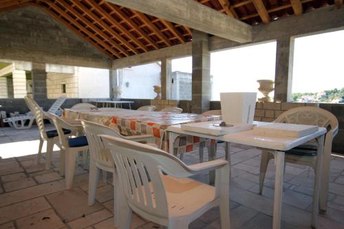 a table and chairs sitting on a patio at Apartments with parking space Lumbarda, Korcula - 179 in Lumbarda