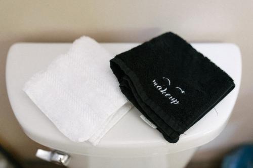 a pile of towels sitting on top of a toilet at The Outpost in Grand Rivers