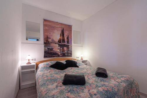 a bedroom with a bed and a painting on the wall at Apartments by the sea Prigradica, Korcula - 248 in Blato