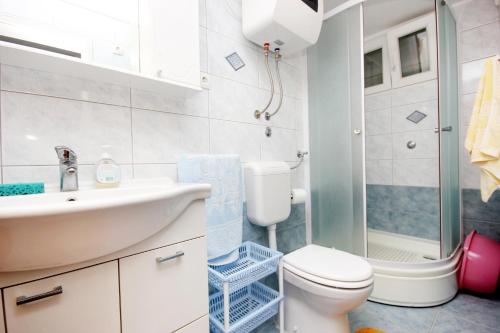 a bathroom with a sink and a toilet and a shower at Apartments by the sea Grscica, Korcula - 169 in Prizba