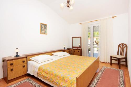 a bedroom with a bed and a table and a chair at Apartments by the sea Grscica, Korcula - 169 in Prizba