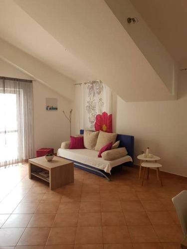 a living room with a white couch and a table at Apartments by the sea Racisce - Korcula - 151 in Račišće