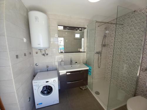 a bathroom with a washing machine and a sink at Apartments by the sea Zavalatica, Korcula - 189 in Zavalatica