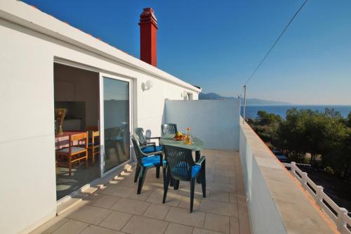 a patio with a table and chairs on a balcony at Apartments by the sea Zavalatica, Korcula - 247 in Zavalatica
