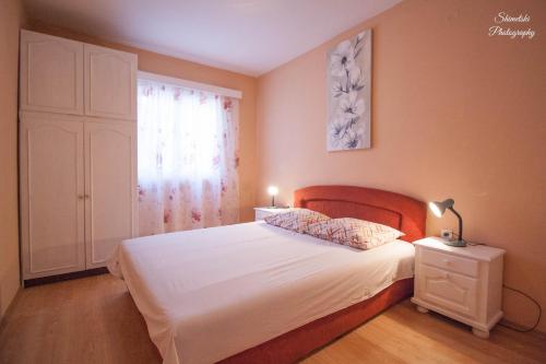 a bedroom with a bed with white sheets and a window at Apartments by the sea Zavalatica, Korcula - 247 in Zavalatica