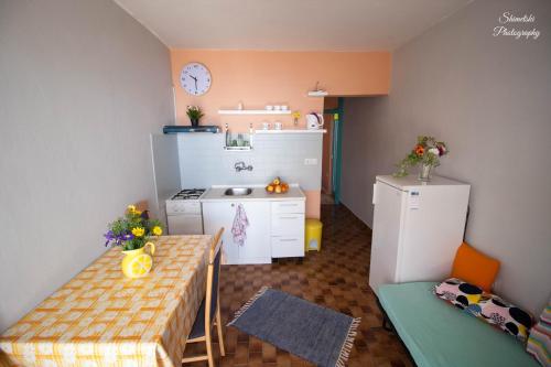 a small kitchen with a table and a refrigerator at Apartments by the sea Zavalatica, Korcula - 247 in Zavalatica