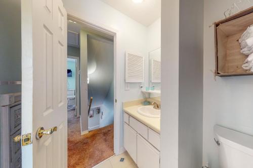 a white bathroom with a sink and a toilet at Gulf Highlands - 173 Damon Circle in Panama City Beach