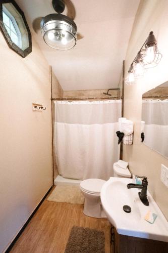 a small bathroom with a toilet and a sink at The Outpost in Grand Rivers