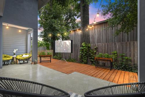 a patio with two chairs and a projection screen at 5Bd 4Bath villa, amazing outdoor space, pet friendly in Orlando