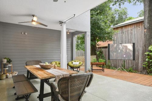 a patio with a wooden table and chairs at Centrally located villa, family reunion, amazing outdoor space, pet friendly in Orlando