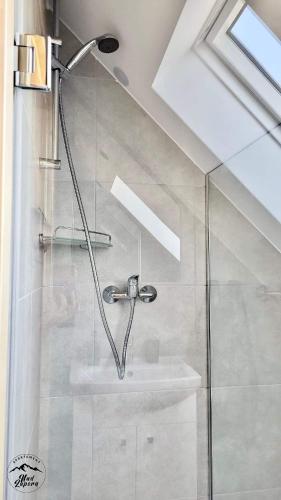 a bathroom with a shower and a sink at Apartament Nad Zaporą in Szlembark