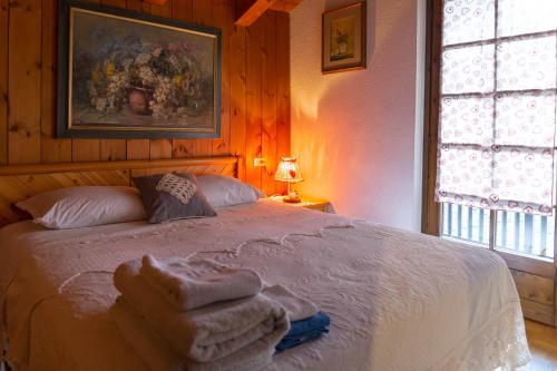 a bedroom with a bed with towels on it at Maison Mont-Blanc in La Salle