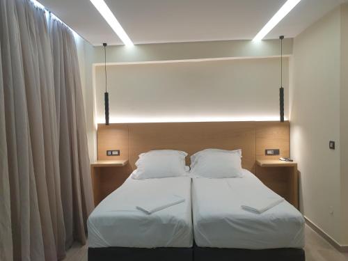 a bedroom with a bed with two white pillows at Platanias Aetheras Beach in Plataniás