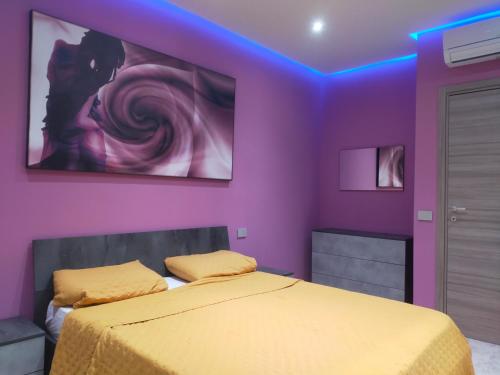 a bedroom with a bed with a purple ceiling at La Selva Incantevole Appartamento in Colazza