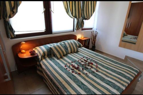 a bedroom with a bed with some bottles on it at City center studio apartment in Malinska