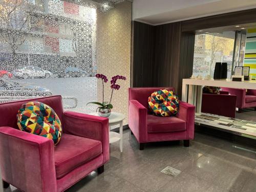 a store with two chairs and a table and a bed at ian Hotel in Buenos Aires