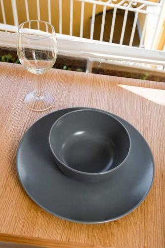 a black plate and a wine glass on a table at Ovadia Somech #4 in Jerusalem