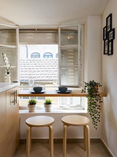a kitchen with two stools in front of a window at Ovadia Somech #4 in Jerusalem