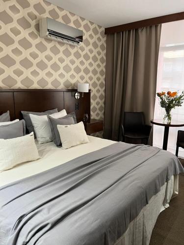 a hotel room with a large bed with white pillows at ian Hotel in Buenos Aires