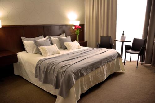 a bedroom with a large bed with two pillows at ian Hotel in Buenos Aires