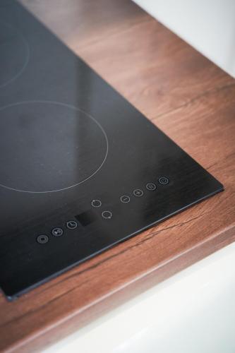 a black stove top on a wooden table at LP Luxury Suite - Old Town Xanthi in Xanthi