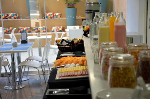 a buffet with several plates of food on a table at ian Hotel in Buenos Aires