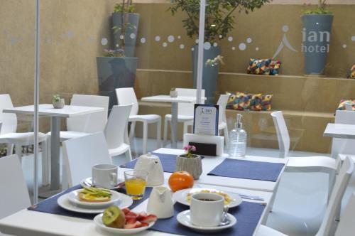 a table with plates of food on top at ian Hotel in Buenos Aires