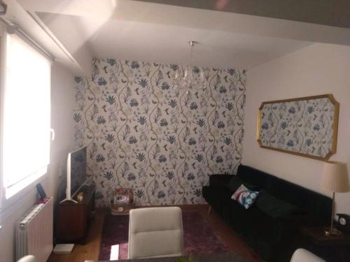 uma sala de estar com um sofá e uma parede em KIKU Apartments II em Bermeo