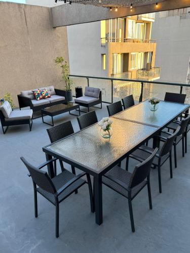 a patio with tables and chairs and a couch at ian Hotel in Buenos Aires