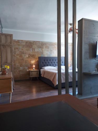 a bedroom with a bed and a brick wall at MoodSolutionsSkg in Thessaloniki