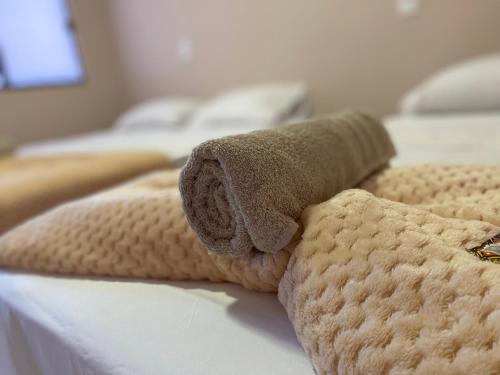 a towel on the side of a bed at Pousada Amanhecer no Jalapão in São Félix do Tocantins