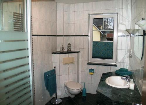 a bathroom with a toilet and a sink and a mirror at Ferienhaus-Binz in Binz