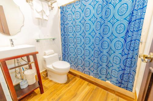 a bathroom with a toilet and a shower curtain at CasaBlanca Hotel in San Juan
