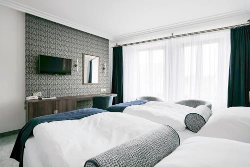 Ein Bett oder Betten in einem Zimmer der Unterkunft Hotel Zlatá Hvězda
