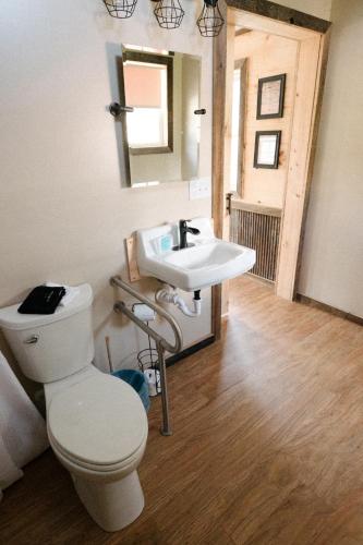 a bathroom with a toilet and a sink at The Outpost in Grand Rivers